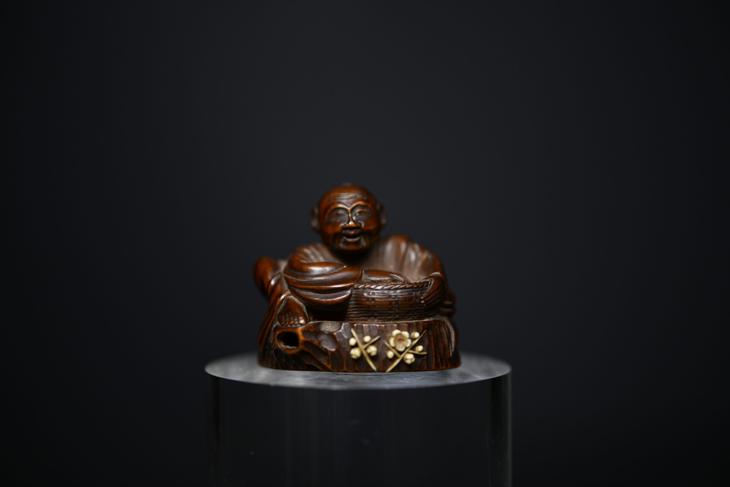 Netsuke man on stump wood