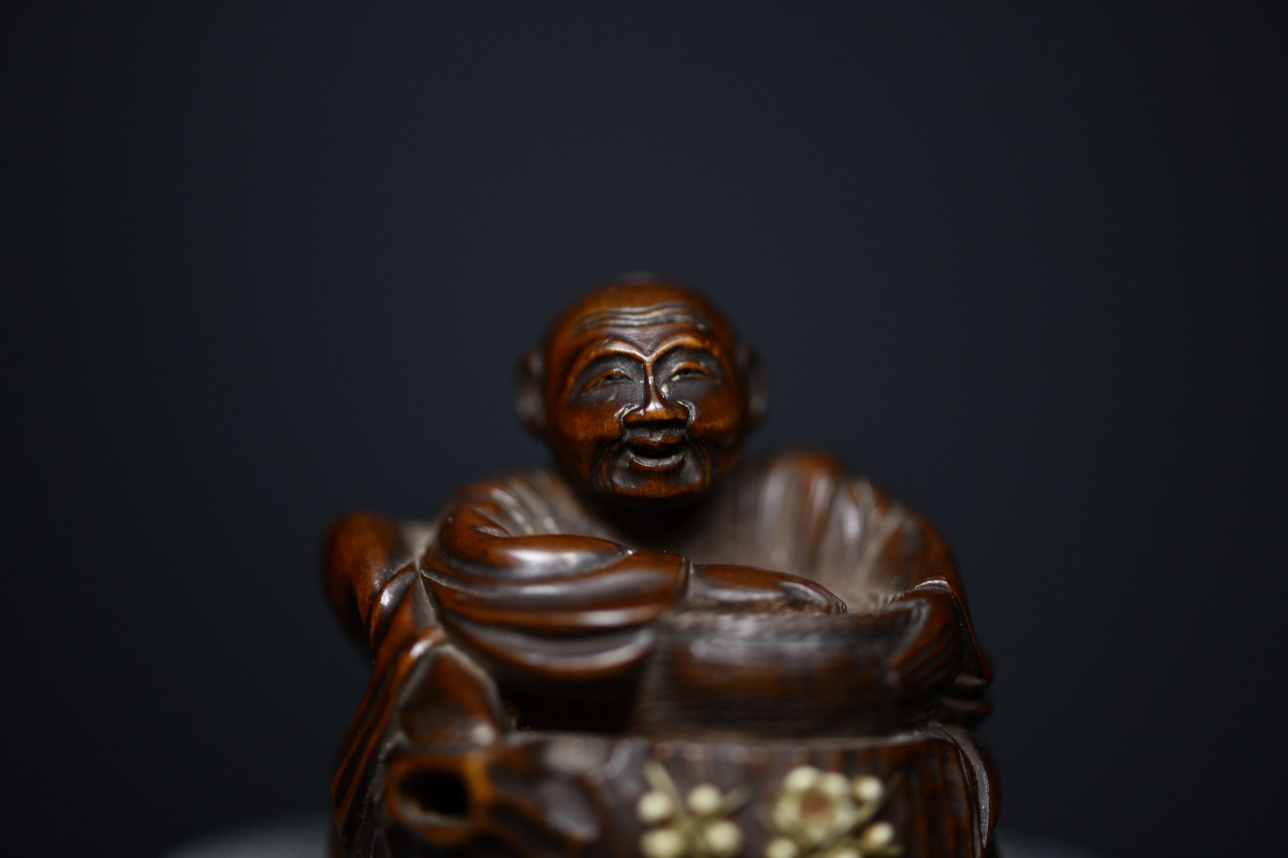 Netsuke man on stump wood
