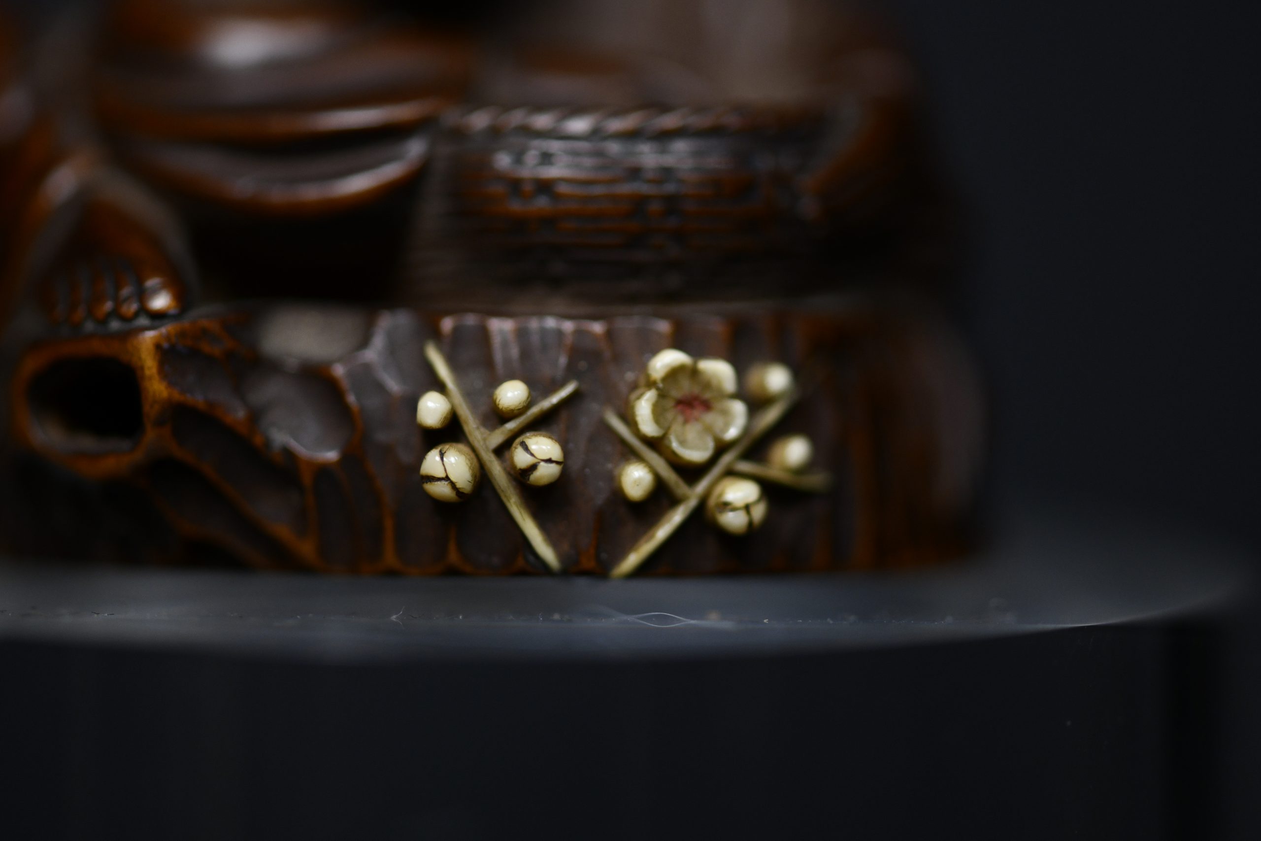 Netsuke man on stump wood