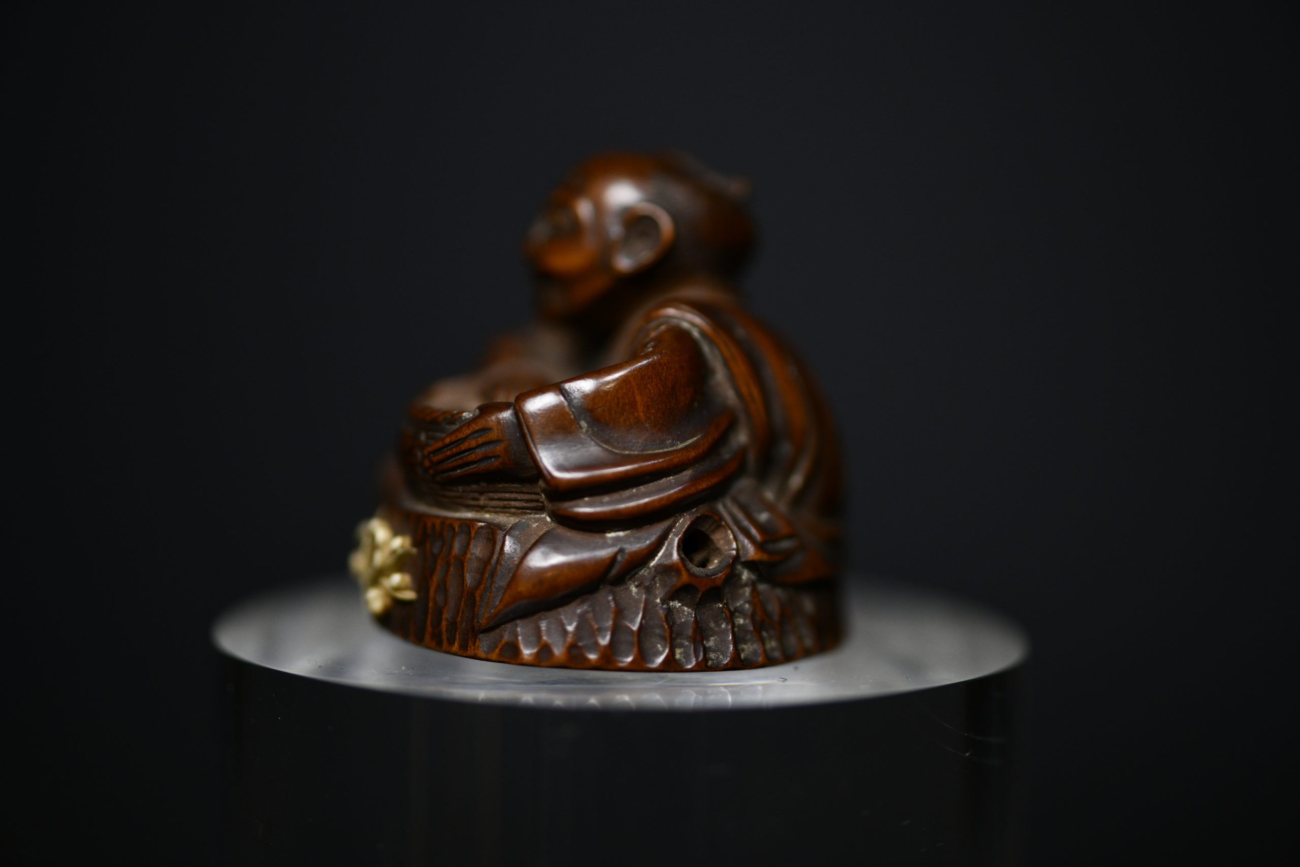 Netsuke man on stump wood