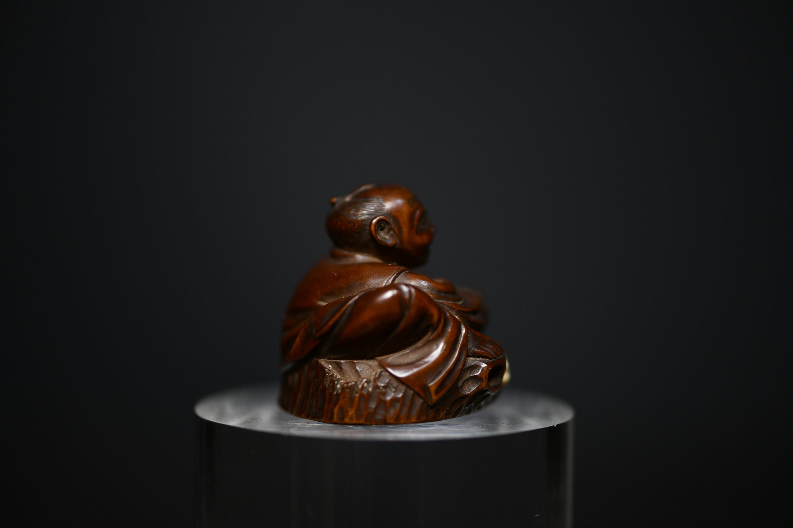 Netsuke man on stump wood