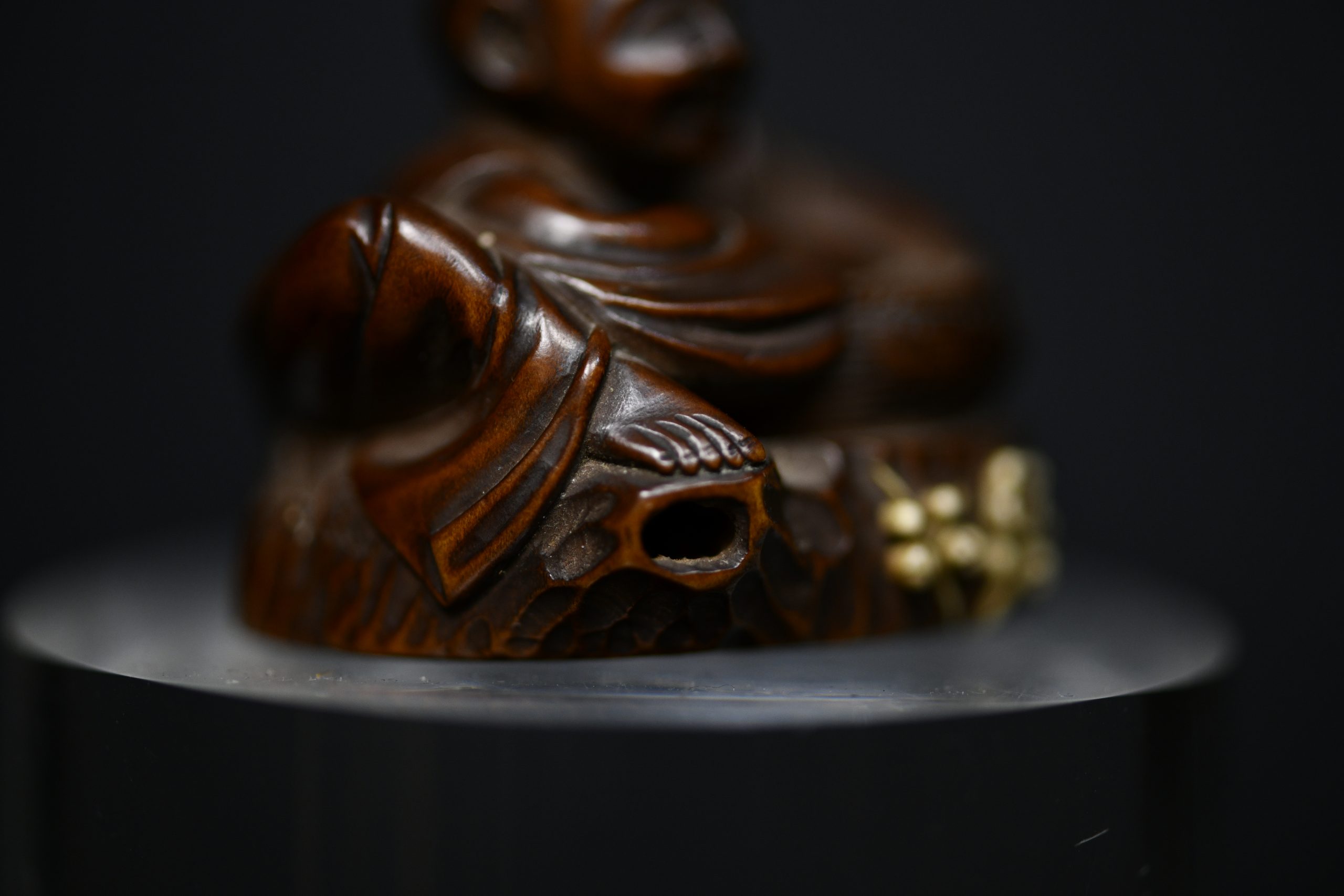 Netsuke man on stump wood