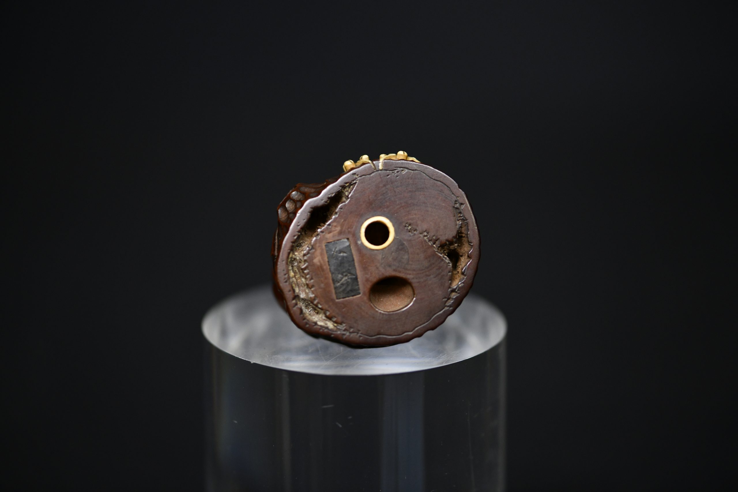 Netsuke man on stump wood