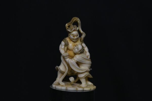 Meiji period ivory okimono of Fudō Myōō in combat with a male figure