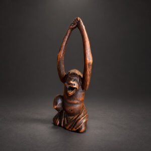 Late Edo Japanese wood netsuke of Tenaga, the legendary long-armed man, kneeling with his elongated arms raised overhead
