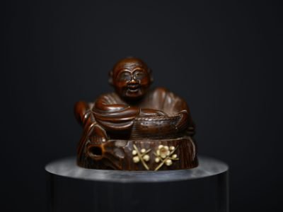 Netsuke man on stump wood