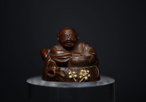 Netsuke man on stump wood
