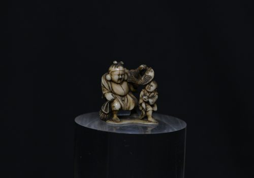 Netsuke Hotei and boy ivory
