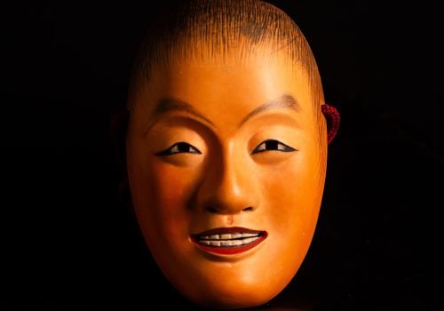 Antique Japanese Noh Mask Dōji – Smiling Youth or Child-Deity Figure with Maroon Cord