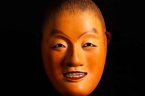 Antique Japanese Noh Mask Dōji – Smiling Youth or Child-Deity Figure with Maroon Cord